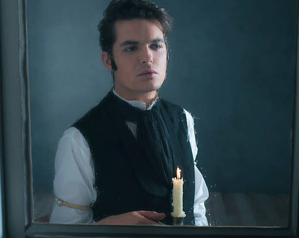 istock Retro dickens style man with candlestick looking out rainy window. 636399874