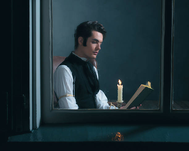 istock Vintage victorian man sitting by rainy window reading book. 636399882