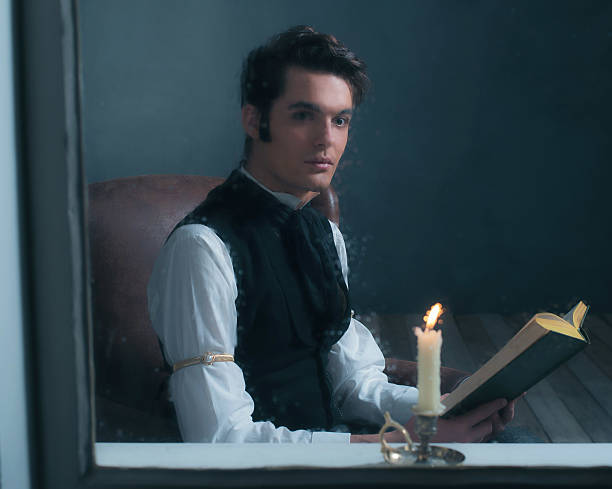 istock Vintage victorian man sitting by rainy window reading book. 636399944
