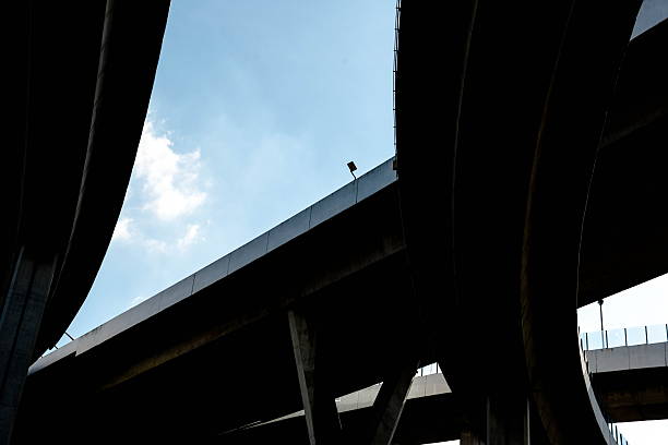 istock Silhouette of highway ramps on a sunny day 636400116