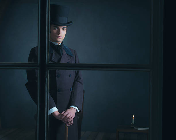 istock Dickens style man standing with cane behind window. 636400150