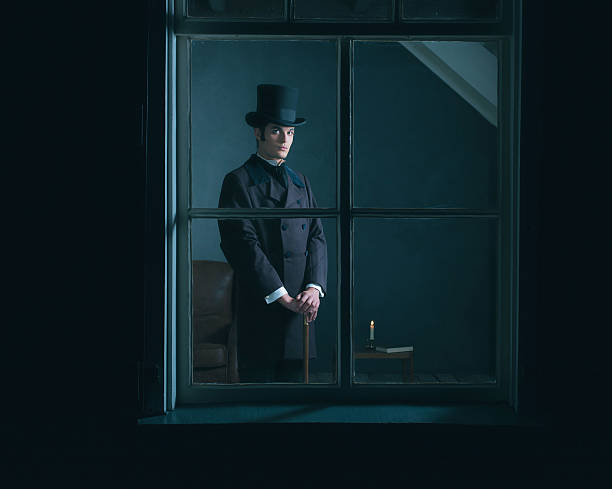istock Dickens style man standing with cane behind window. 636400180