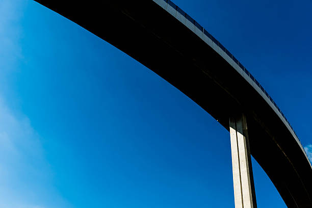 istock Silhouette of highway ramps on a sunny day 636400208