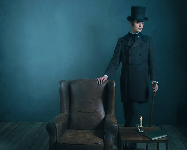 istock Retro dickens style man standing with cane next to chair. 636400262