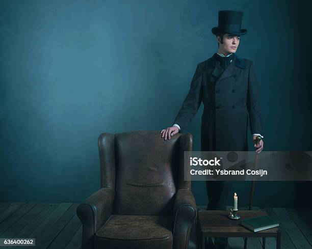 Retro Dickens Style Man Standing With Cane Next To Chair Stock Photo - Download Image Now