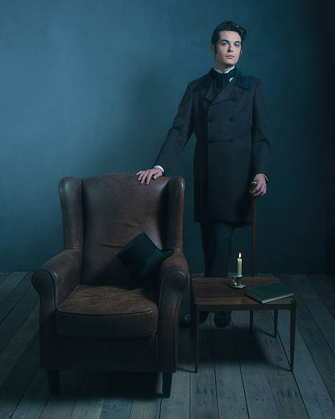 istock Retro dickens style man standing with cane next to chair. 636400282