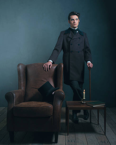 istock Retro dickens style man standing with cane next to chair. 636400308