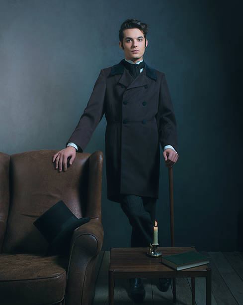 Retro dickens style man standing with cane next to chair.
