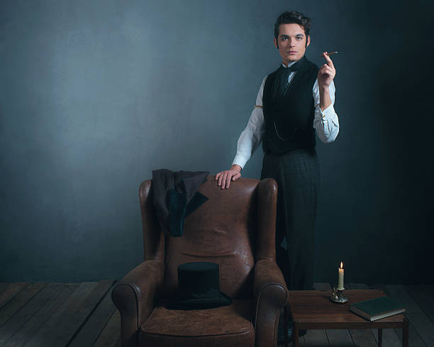 istock Vintage victorian man standing next to chair smoking cigarette. 636400352