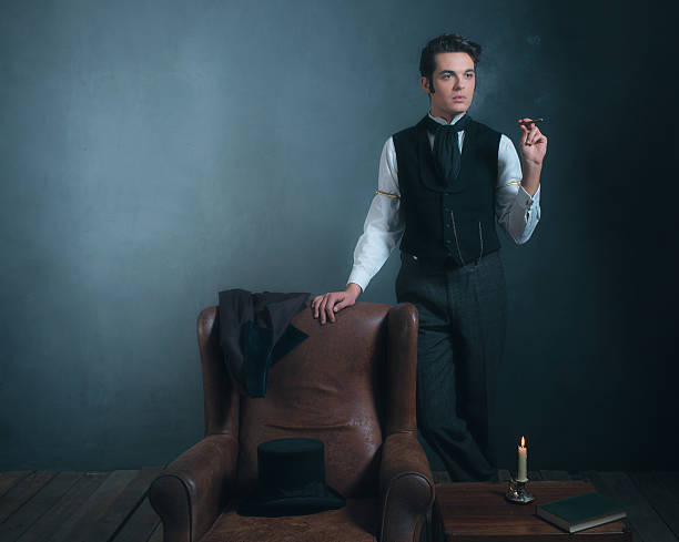 istock Vintage victorian man standing next to chair smoking cigarette. 636400406