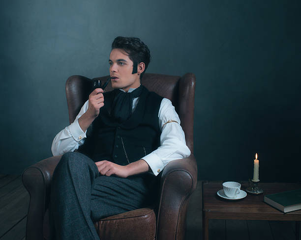 istock Retro dickens style man smoking pipe. Sitting in leather chair. 636400564