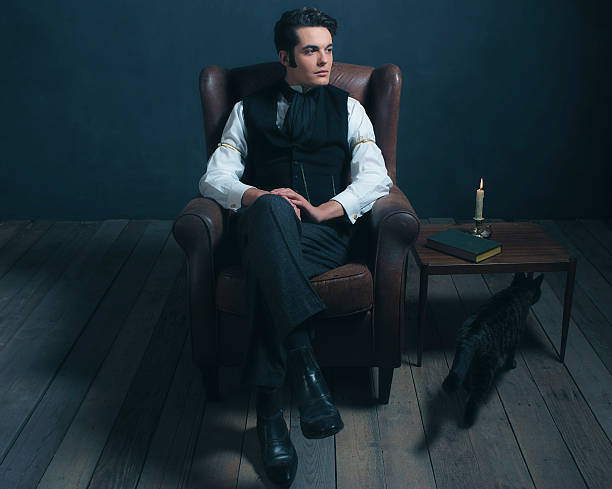 istock Retro victorian dickens man sitting on leather chair. 636400790