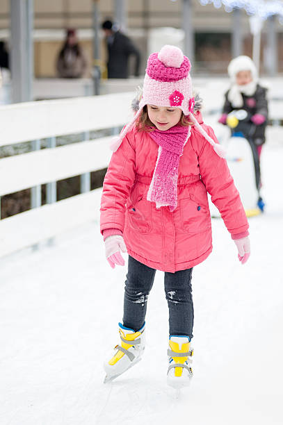 istock Little girl skating at the open ice rink 636400896