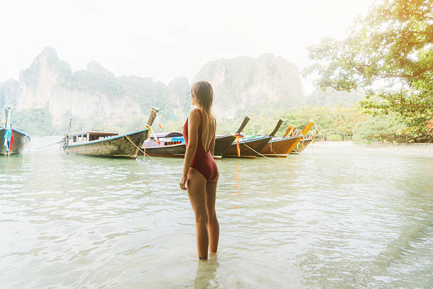 istock Woman on beach in Thailand 636402546