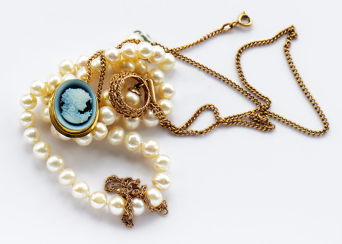 Vintage  gold jewelry pendant, brooch, cameo and white pearl  isolated