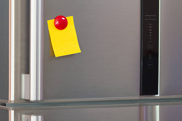 istock Abstract of Blank paper and post-it on refrigerator door. 636406994