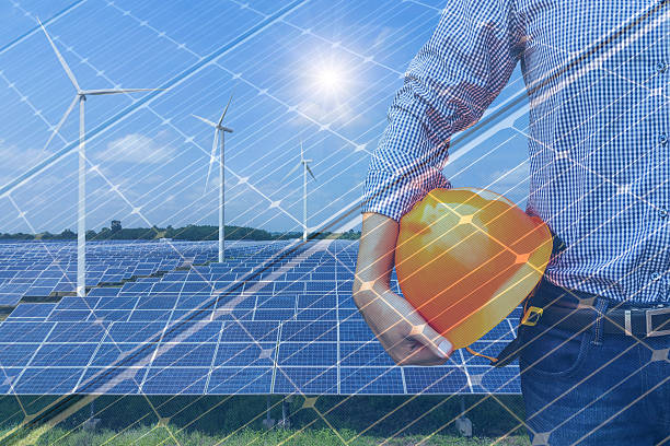 istock Double exposure engineer holding safety helmet in solar power station 636407020