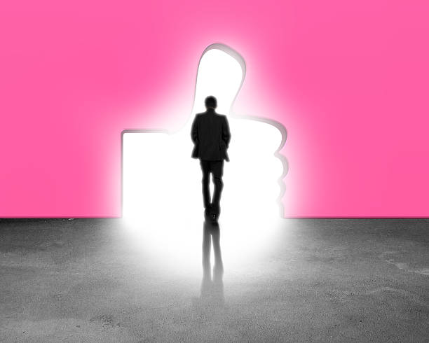istock Man walking through thumb up shape door 636408394
