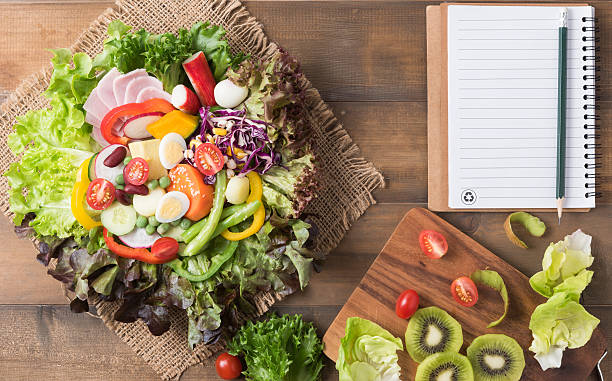 istock fresh mix vegetation salad on brown wood background 636409134