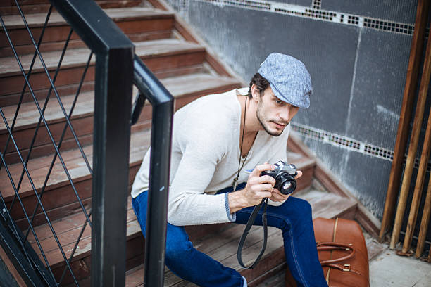 A young photographer taking pictures on a mountain hike with an analog camera