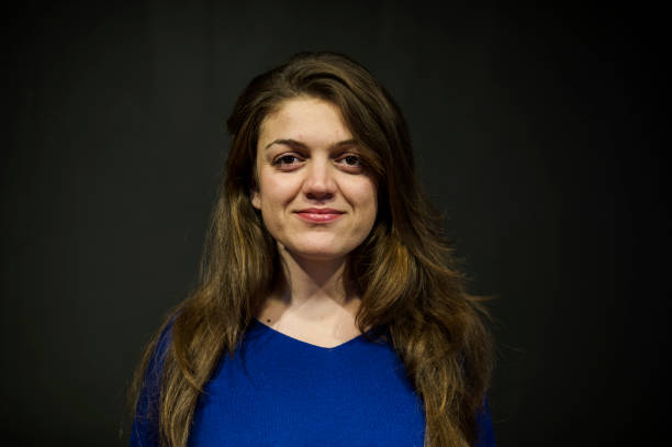 istock Young Woman Posing Front of a Black Wall 636413304