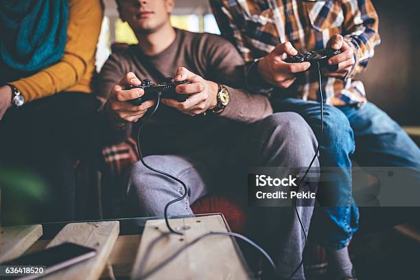Focused On The Game Stock Photo - Download Image Now - Video Game, Friendship, Gamer