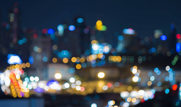 istock Blurred bokeh lights intersection with city downtown 636421354