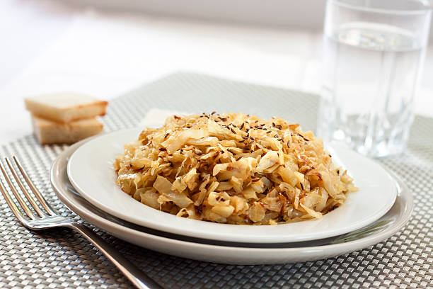 istock Fried cabbage with caraway and garlic on a plate 636424574