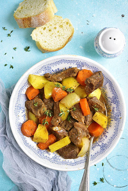 istock Beef stew with vegetables and thyme.Top view. 636425028