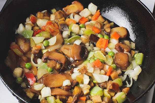 Roasted vegetables in a frying pan. red, green, brown
