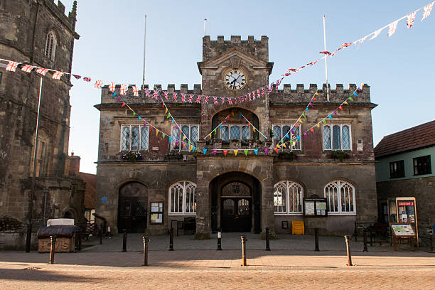 Bunting on Shaftesbury Town Hall Shaftesbury, England, United Kingdom - June 28, 2012: Bunting decorates the castellated stone town hall of Shaftesbury in Dorset during Queen Elizabeth's Jubilee celebrations. blackmore vale stock pictures, royalty-free photos & images