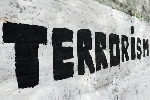 The word terrorism written over brick wall