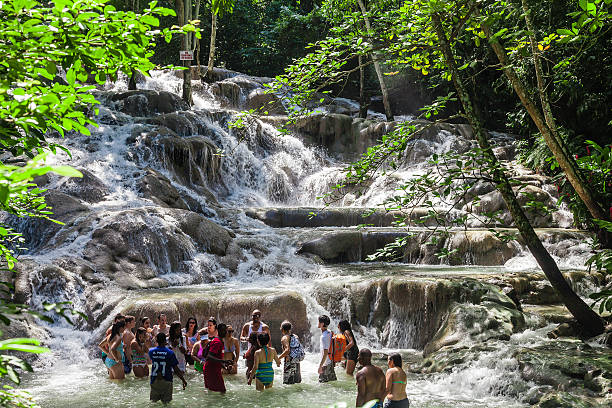 The Dunn's River Falls in Jamaica Ocho Rios, Jamaica - November 15, 2016: The Dunn's River Falls are waterfalls in Ocho Rios in Jamaica, which can be climbed by tourists. dunns river falls stock pictures, royalty-free photos & images