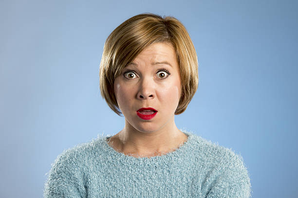 istock woman in surprise shock face expression expressing anxiety and fear 636432902