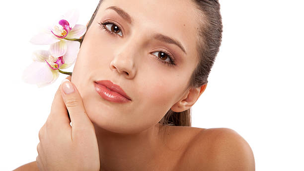 istock woman and orchid 636436576