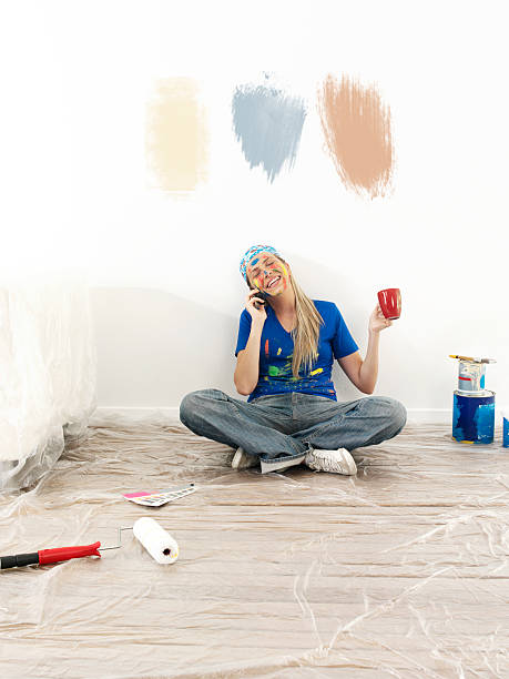 istock Young woman painting 636440590