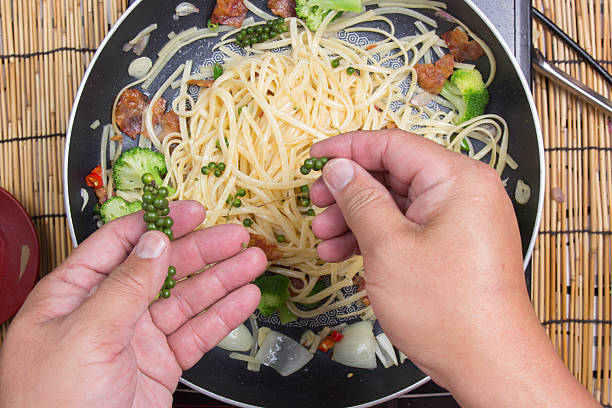 istock Chef putting green pepper for cooking 636440866
