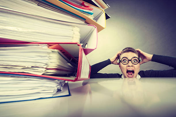 istock Accountant terrified of pils of binders. 636440996
