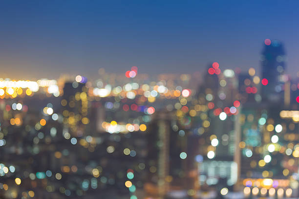 istock Twilight, blurred bokeh lights city downtown 636443060