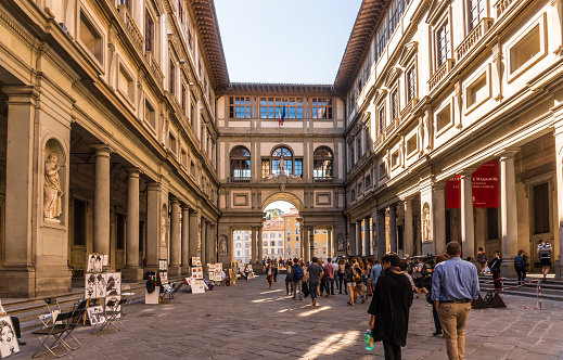 Florence, Italy - October 5, 2016: Florence, Italy - Oct 5, 2016. Tourists browsing through The Uffizi Gallery museum in Florence, and walking toward the Arno river.