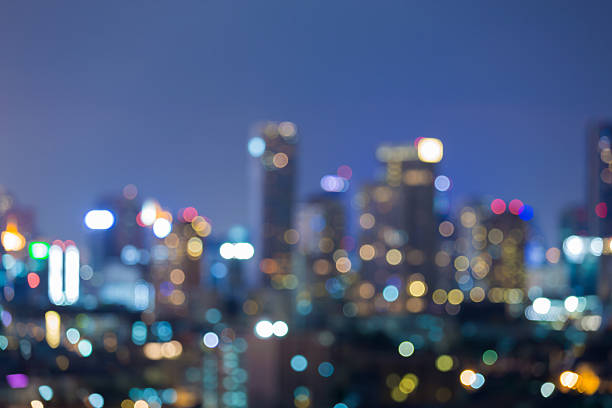 istock Abstract blurred bokeh lights office building background 636443830