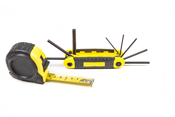 istock Measuring tape and hex wrench set isolated on white background 636444604