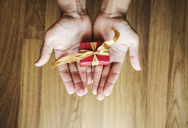 istock Asian male hand holding red gift box 636447518