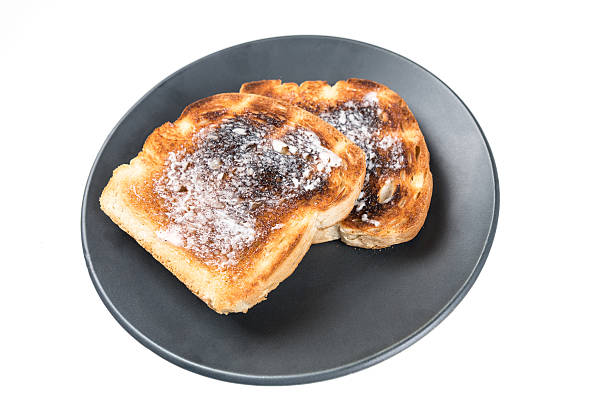istock Burned whole grain toast isolated on white background 636447736
