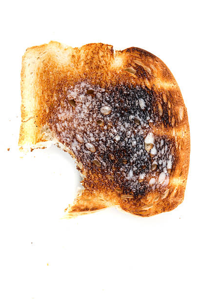 istock Burned whole grain toast isolated on white background 636447842