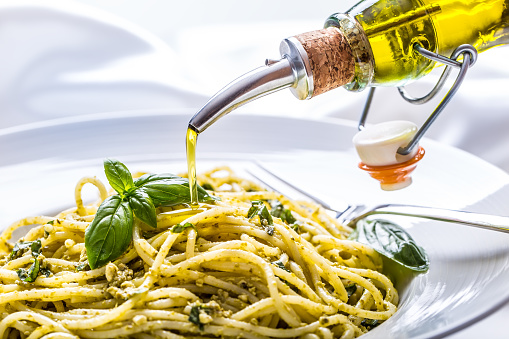 Spaghetti. Spaghetti with homemade pesto sauce olive oil and basil leaves.Spaghetti. Spaghetti with homemade pesto sauce olive oil and basil leaves.