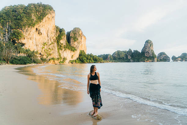 istock Woman walking on the beach 636450902