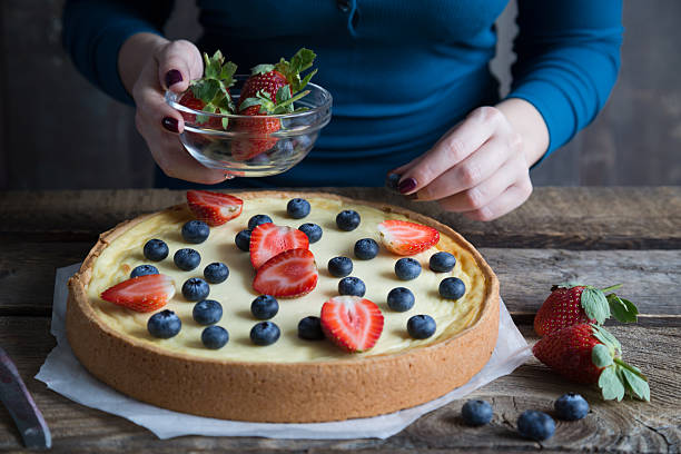 istock The girl is preparing a cheesecake with fresh berries 636450998