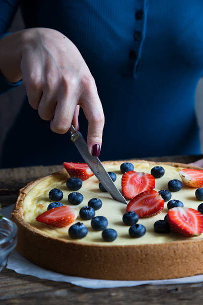 istock The girl is preparing a cheesecake with fresh berries 636451202