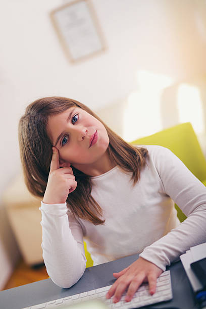 istock Beautiful girl working on her school project at home. 636452396